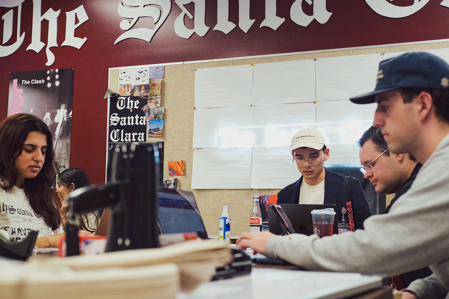 Students working around a table for The Santa Clara.
