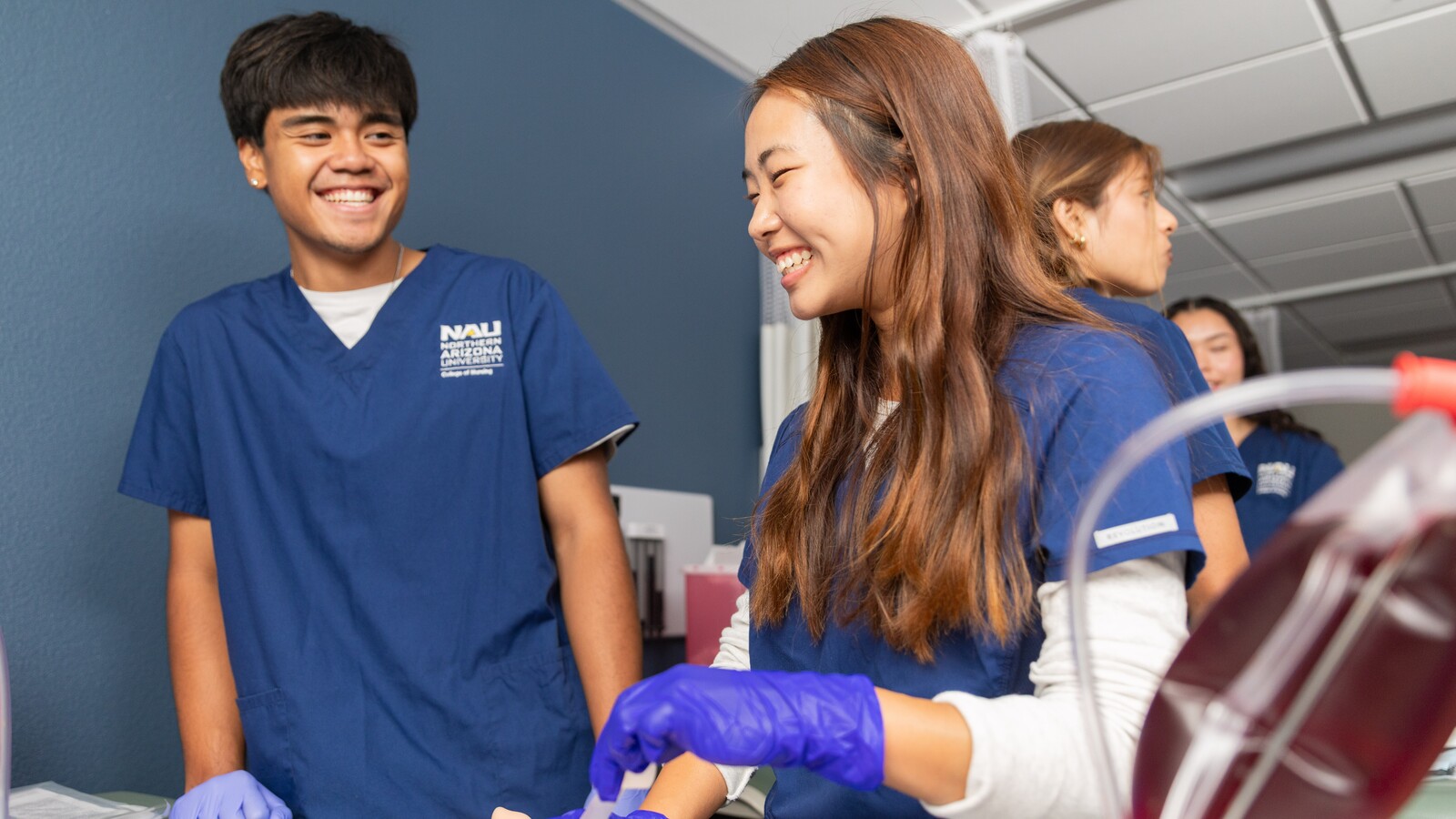 Two nursing students laugh together. Two nursing students laugh together.