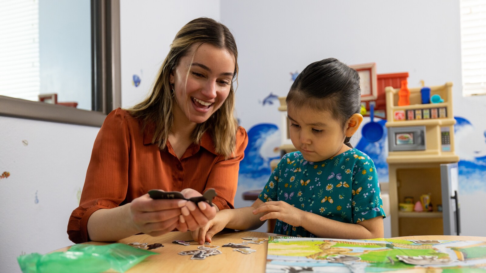 An NAU student interacts with a child in a classroom.