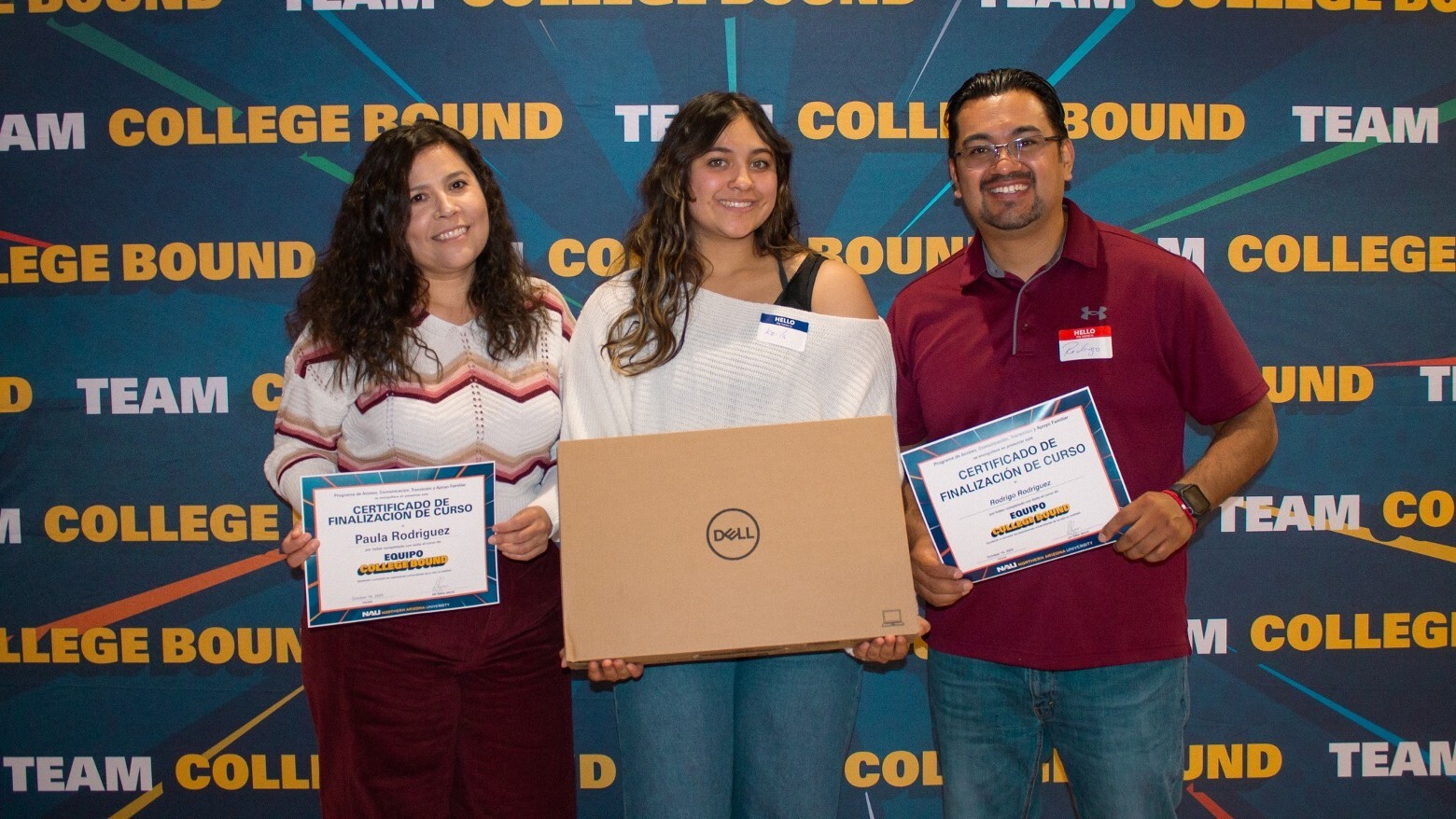 An NAU student and her parents pose with a Dell laptop at a Team College Bound event. An NAU student and her parents pose with a Dell laptop at a Team College Bound event.