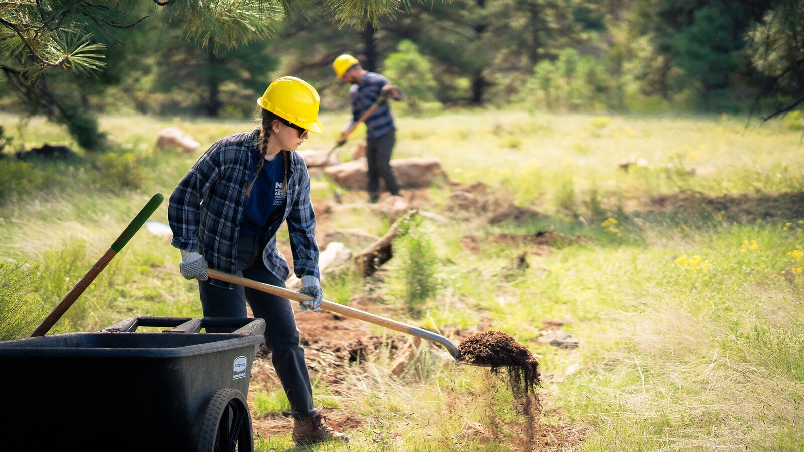 An NAU student digs a hole for a volunteer project.