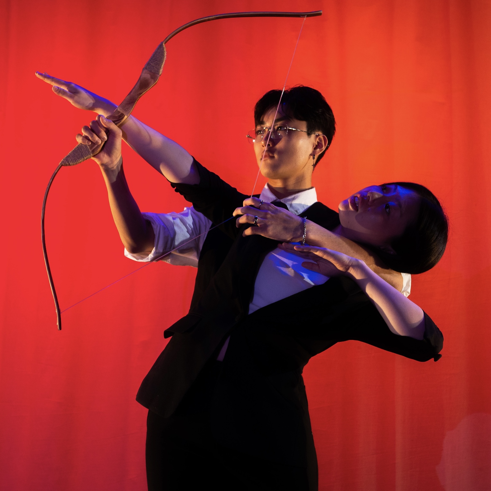 Artistic depiction of two people using a bow and arrow Artistic depiction of two people using a bow and arrow