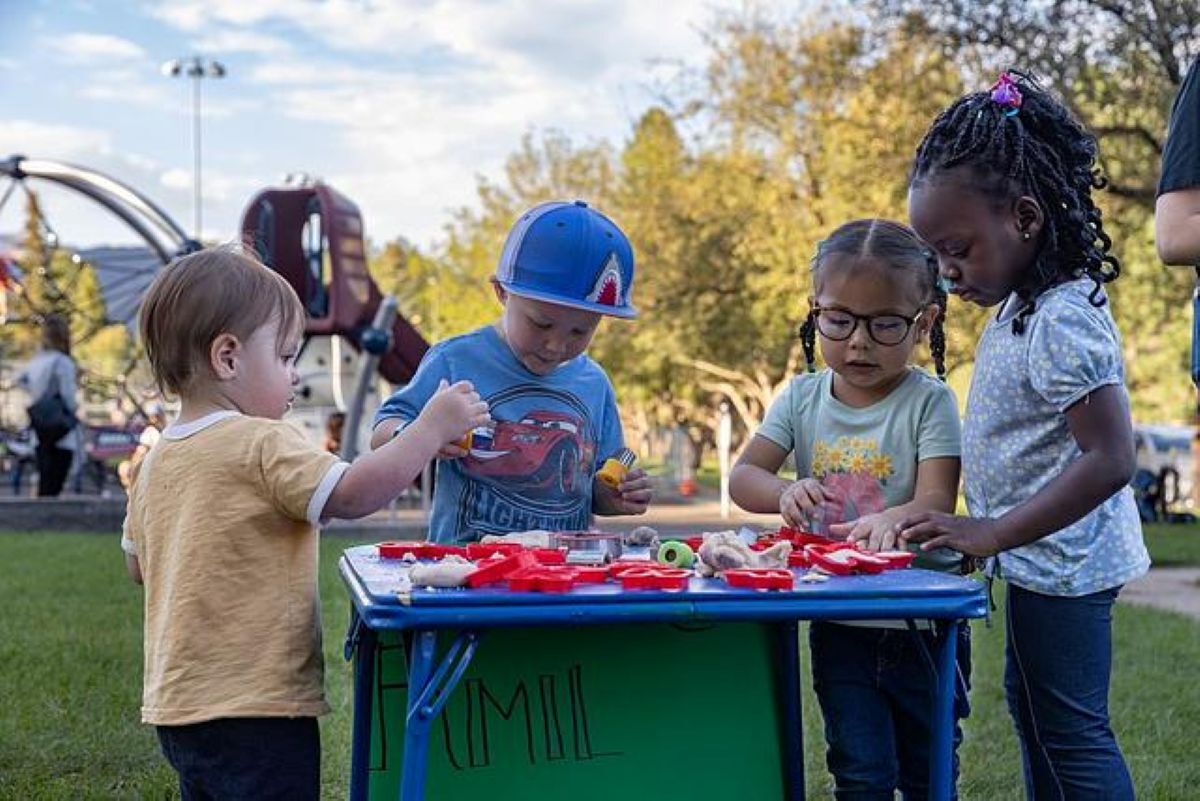 A group of four children play with one another. A group of four children play with one another.