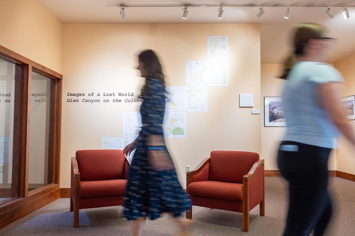 A blurry photo of two people at an NAU art exhibit. A blurry photo of two people at an NAU art exhibit.