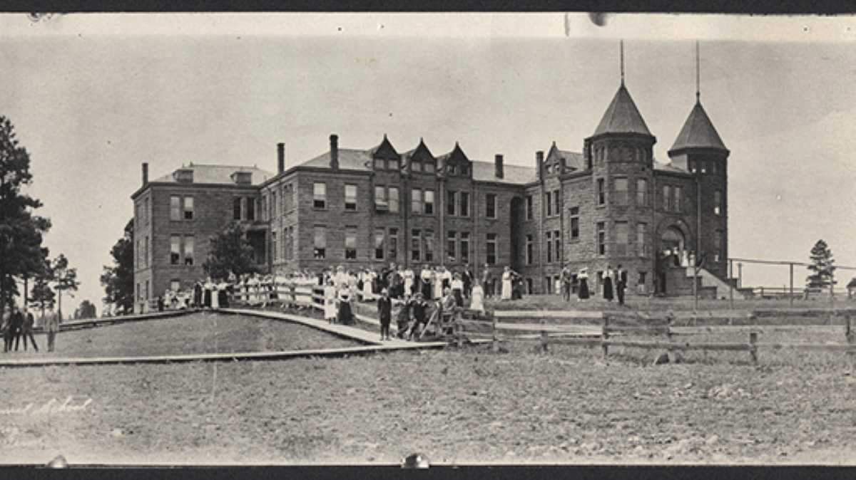 An archival black and white photo that depicts Old Main at NAU. An archival black and white photo that depicts Old Main at NAU.